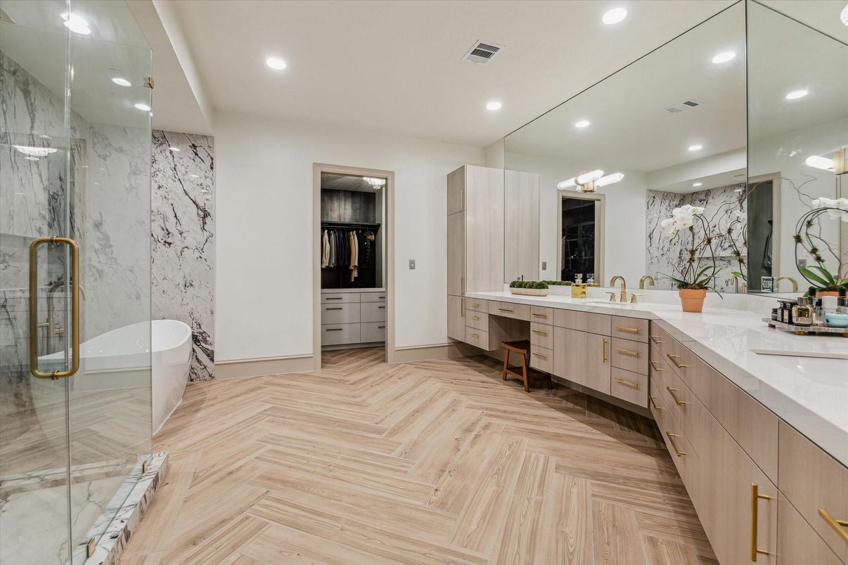 Bathroom, Dual Sink Vanities, Free Standing Baths, Glass Shower, Interior, Marble Walls, Recessed Lighting, Wood Texture Flooring