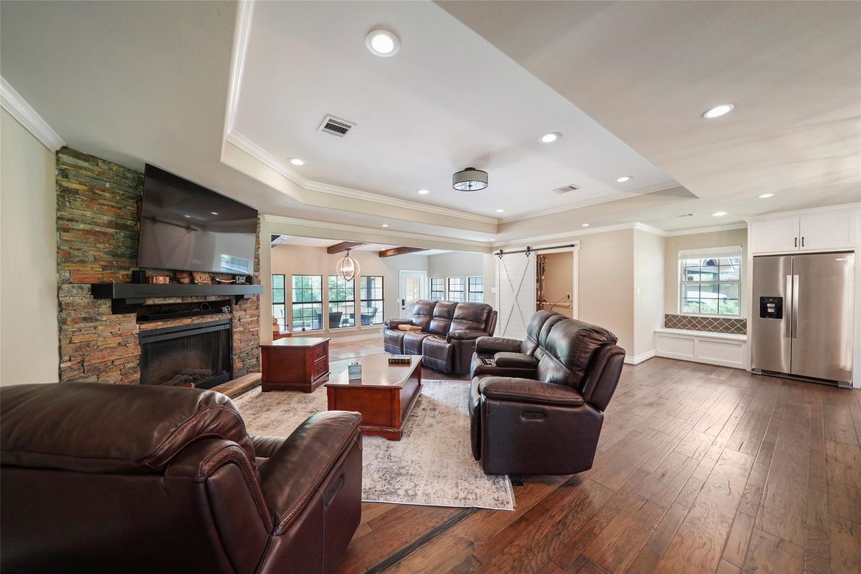 Fireplace, Interior, Kitchen, Living room, Recessed Lighting, Stainless Steel Appliances, Stone Walls, Wood Texture Flooring