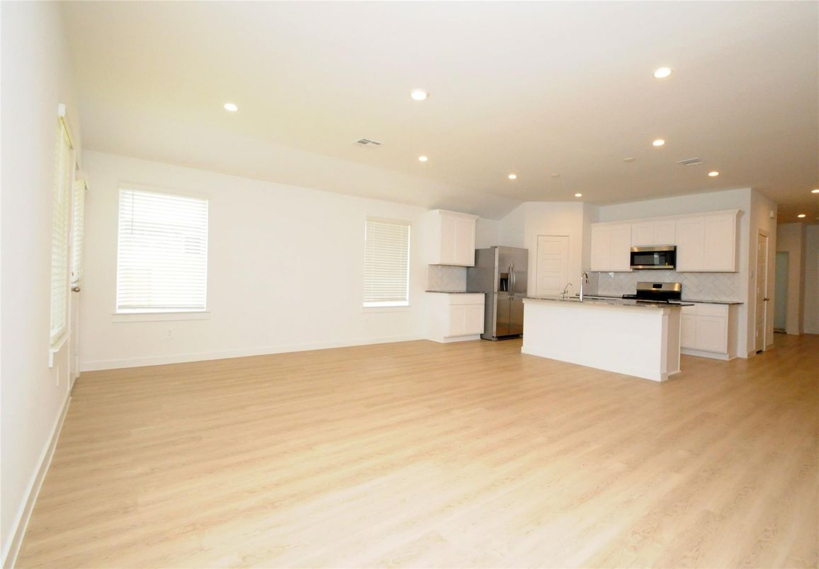 Empty room, Interior, Kitchen, Recessed Lighting, Stainless Steel Appliances, Wood Texture Flooring