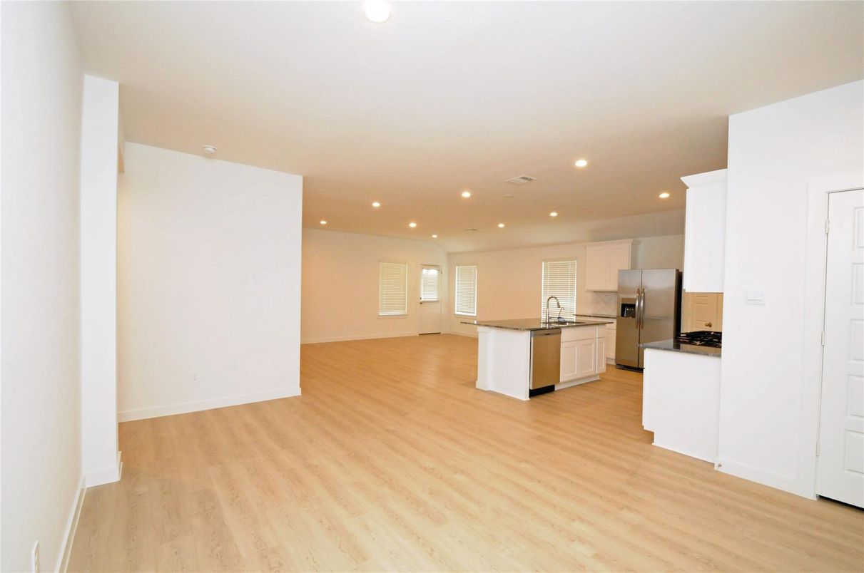 Empty room, Interior, Kitchen, Recessed Lighting, Stainless Steel Appliances, Wood Texture Flooring