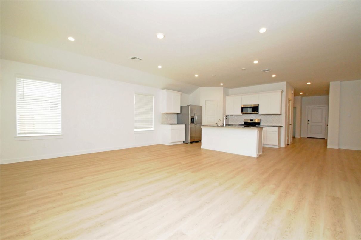 Empty room, Interior, Kitchen, Recessed Lighting, Stainless Steel Appliances, Wood Texture Flooring