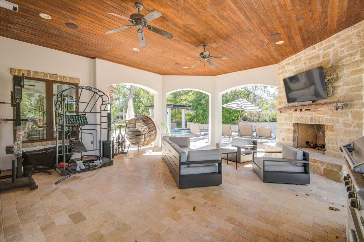 Fireplace, Fitness Equipment, Interior, Living room, Recessed Lighting, Stone Walls, Wooden Ceilings