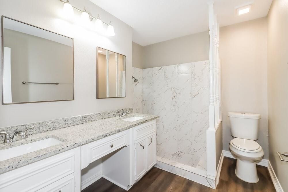 Bathroom, Dual Sink Vanities, Interior, Marble Walls, Recessed Lighting, Wood Texture Flooring