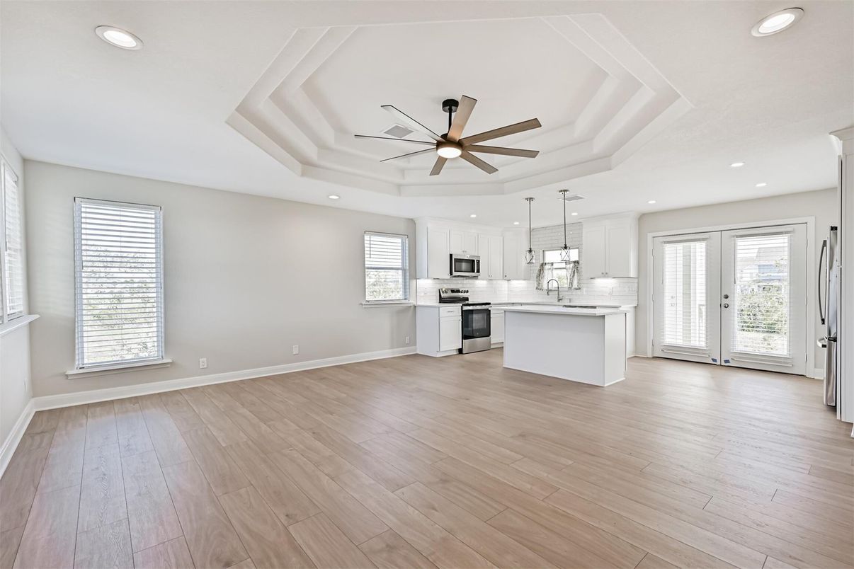 Empty room, Interior, Kitchen, Pendant Lights, Recessed Lighting, Stainless Steel Appliances, Wood Texture Flooring