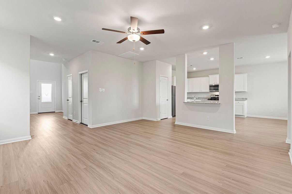 Empty room, Interior, Kitchen, Recessed Lighting, Stainless Steel Appliances, Wood Texture Flooring