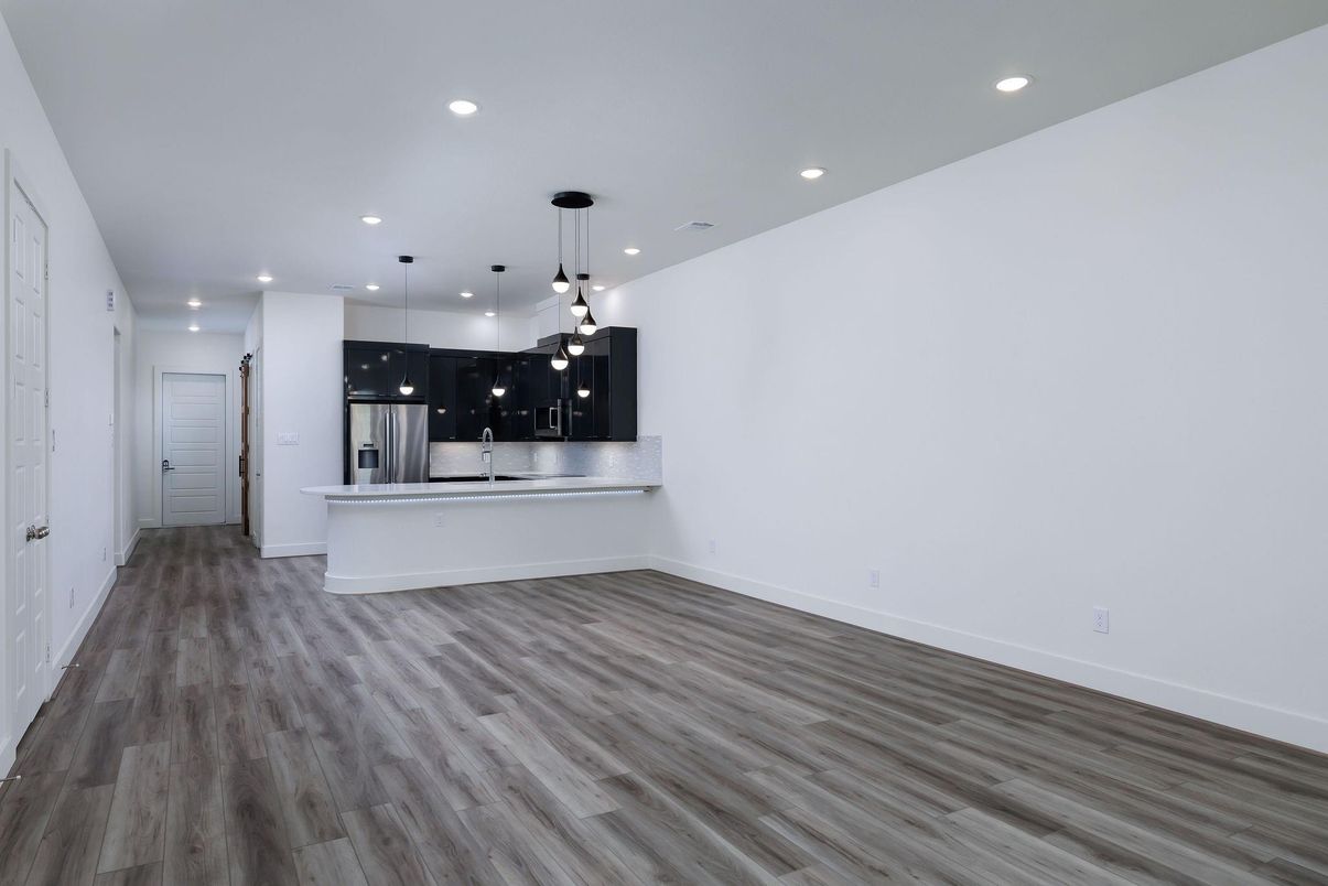 Empty room, Interior, Kitchen, Pendant Lights, Recessed Lighting, Stainless Steel Appliances, Wood Texture Flooring