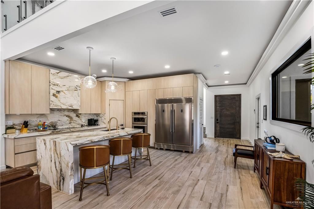 Interior, Kitchen, Marble Walls, Pendant Lights, Recessed Lighting, Stainless Steel Appliances, Wood Texture Flooring