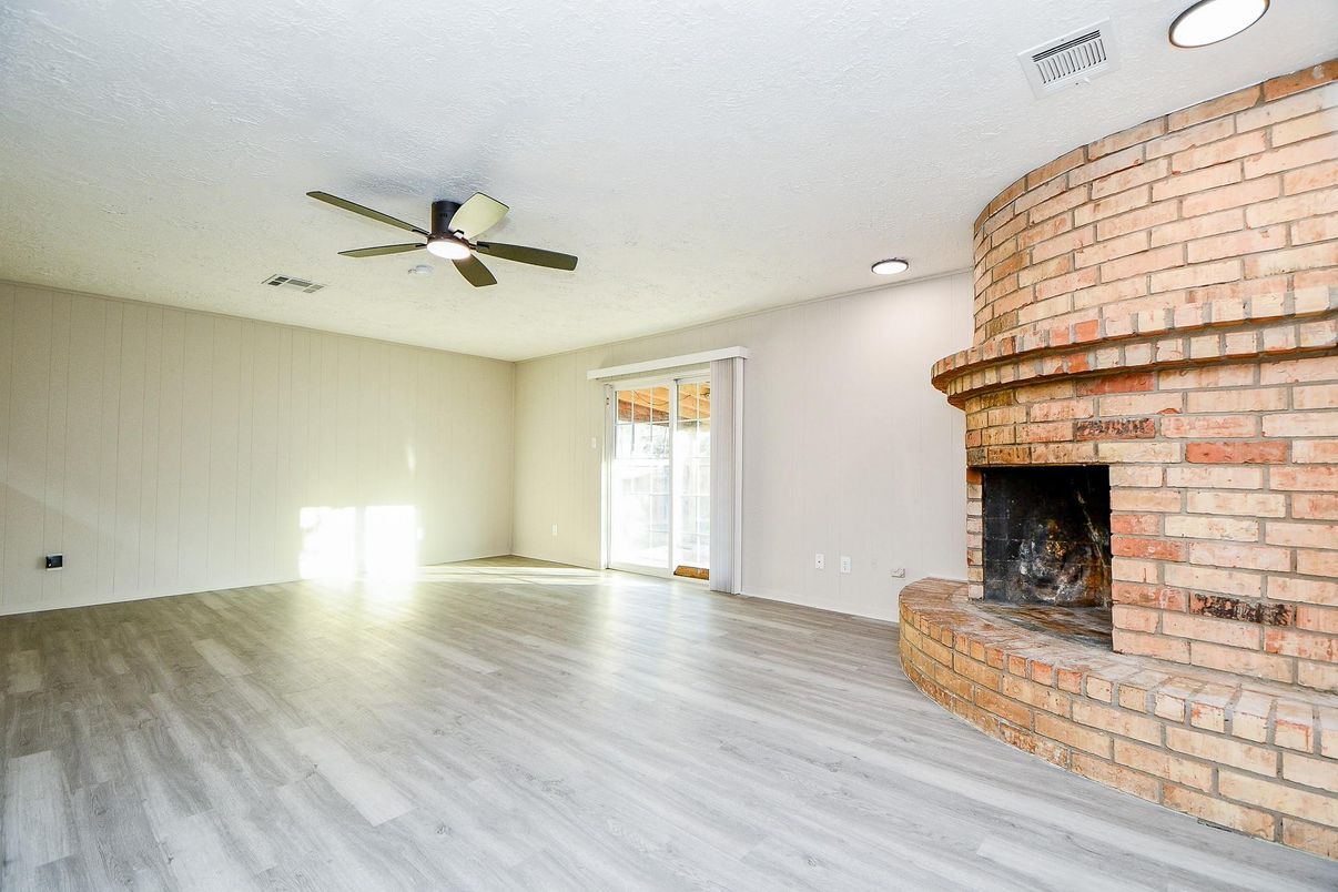 Empty room, Fireplace, Interior, Recessed Lighting, Stone Walls, Wood Texture Flooring
