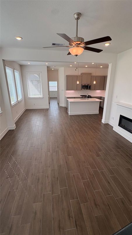 Empty room, Fireplace, Interior, Kitchen, Pendant Lights, Recessed Lighting, Wood Texture Flooring