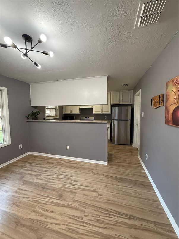 Empty room, Interior, Kitchen, Pendant Lights, Stainless Steel Appliances, Wood Texture Flooring