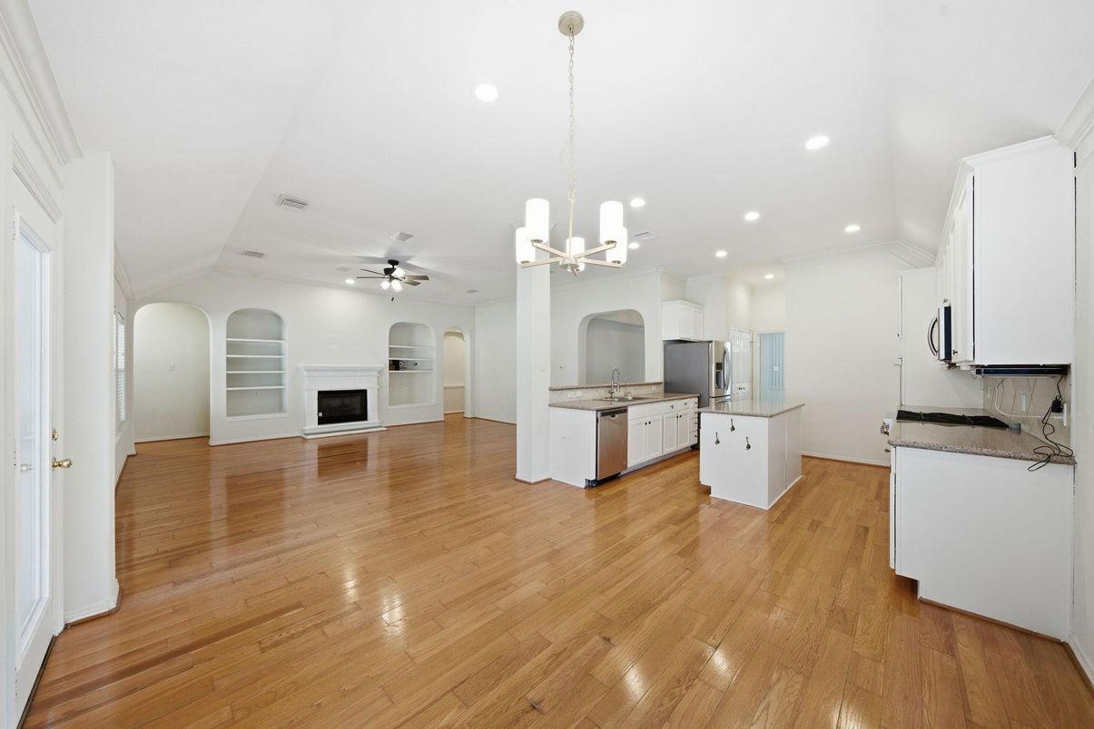 Empty room, Fireplace, Interior, Kitchen, Pendant Lights, Recessed Lighting, Wood Texture Flooring