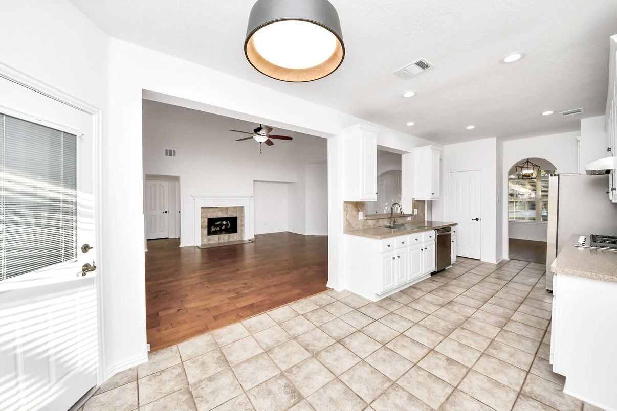 Empty room, Fireplace, Interior, Kitchen, Recessed Lighting, Wood Texture Flooring