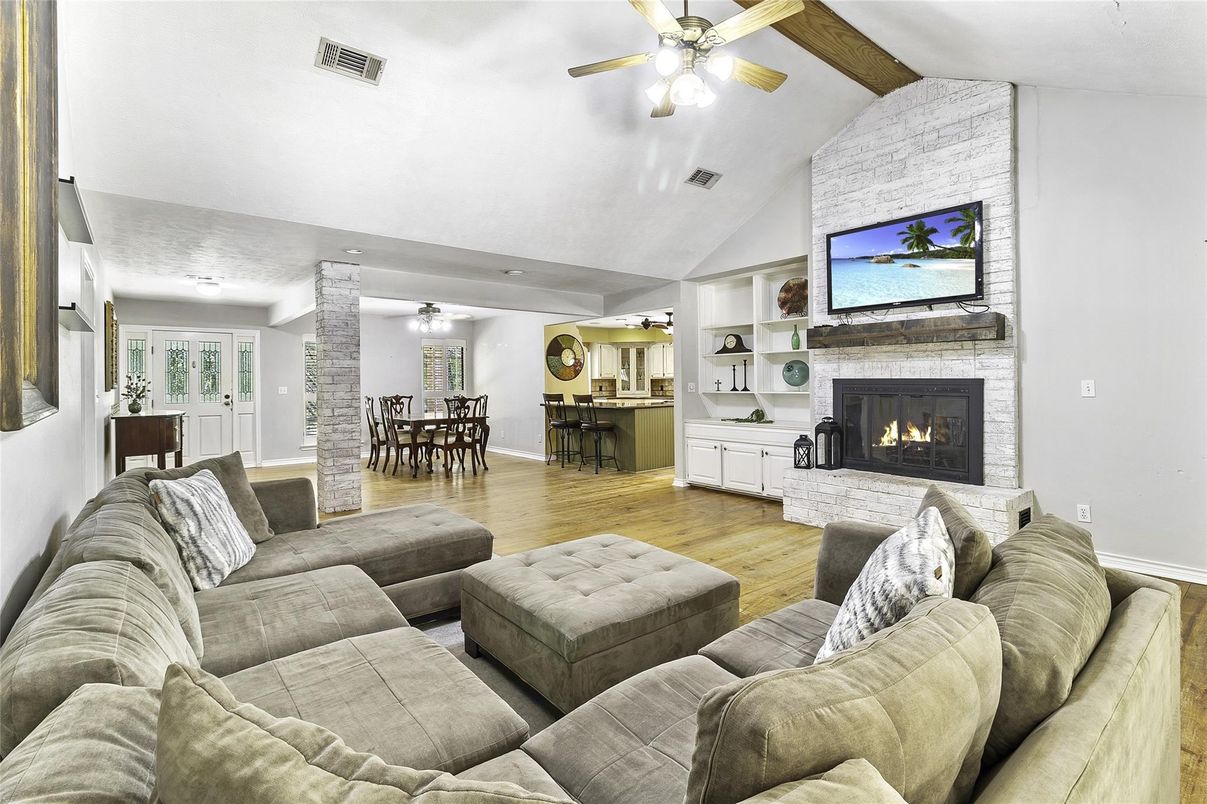 Dining room, Fireplace, Interior, Living room, Recessed Lighting, Stone Walls, Wood Texture Flooring