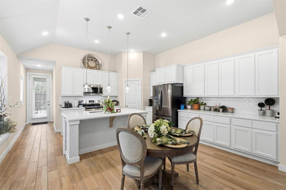 Dining room, Interior, Kitchen, Pendant Lights, Recessed Lighting, Stainless Steel Appliances, Wood Texture Flooring