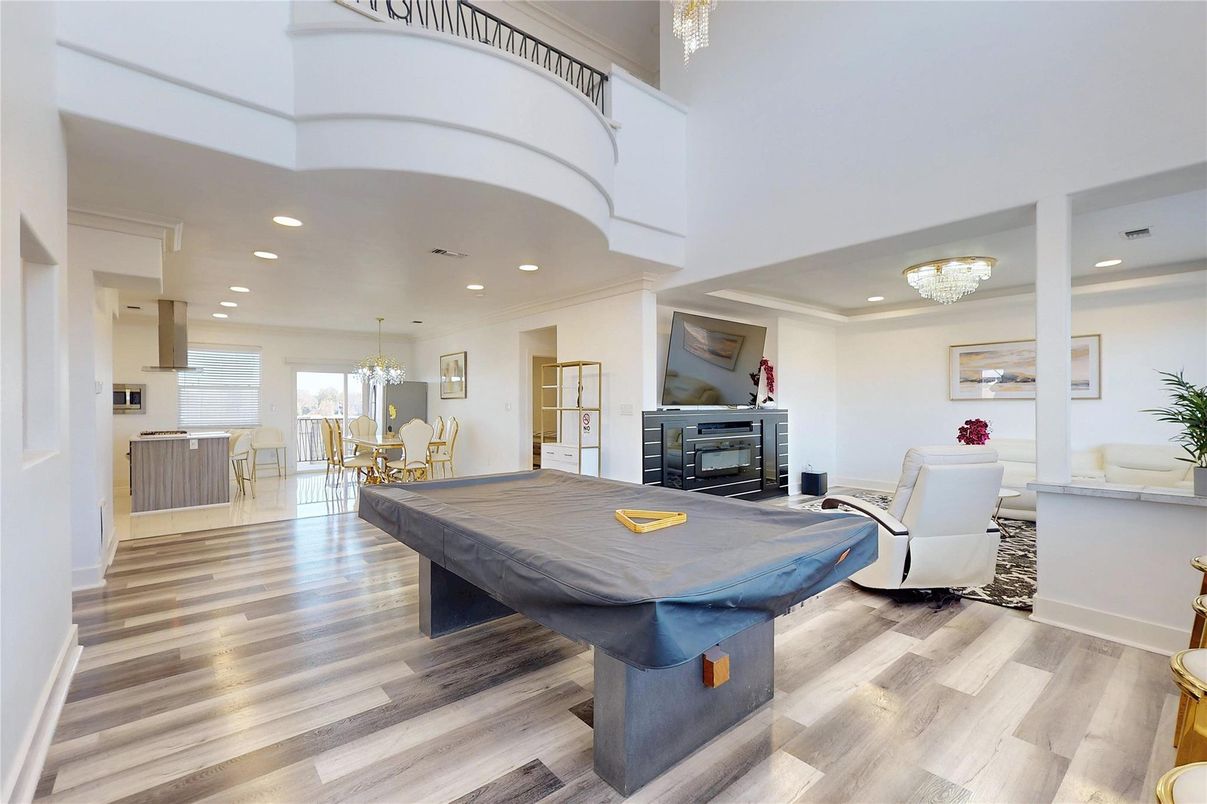 Billiard Table, Chandelier, Dining room, Fireplace, Game Room, Interior, Living room, Pendant Lights, Recessed Lighting, Wood Texture Flooring