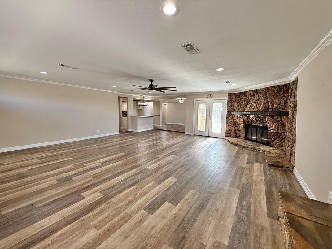 Empty room, Fireplace, Interior, Recessed Lighting, Stone Walls, Wood Texture Flooring