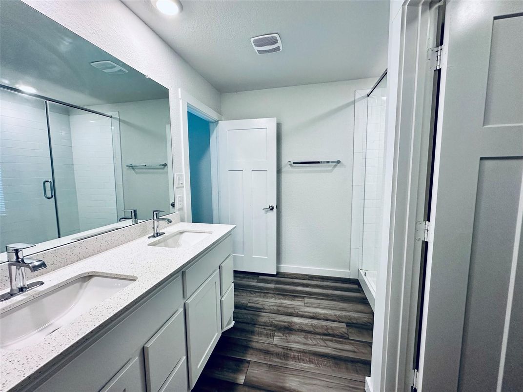 Bathroom, Dual Sink Vanities, Glass Shower, Interior, Recessed Lighting, Wood Texture Flooring