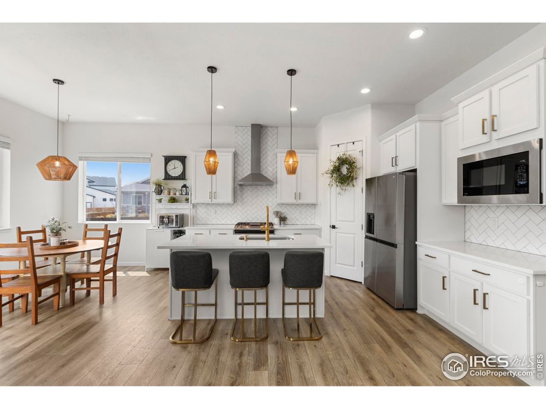 Dining room, Interior, Kitchen, Pendant Lights, Recessed Lighting, Stainless Steel Appliances, Wood Texture Flooring