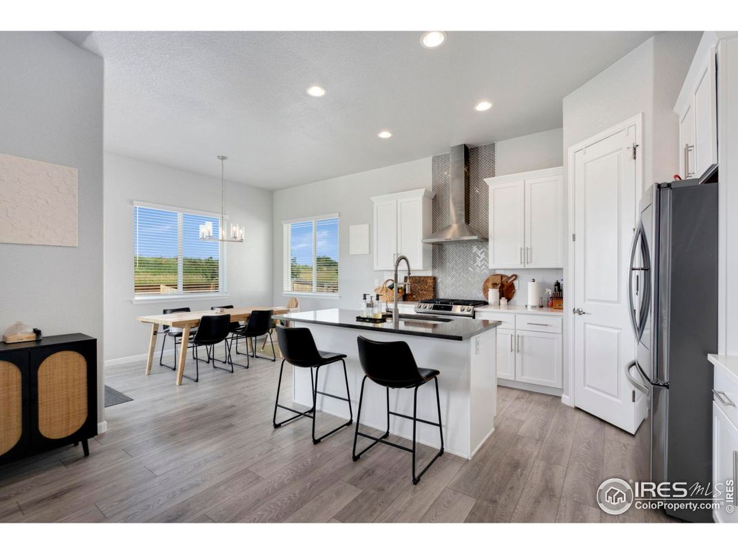 Dining room, Interior, Kitchen, Pendant Lights, Recessed Lighting, Stainless Steel Appliances, Wood Texture Flooring