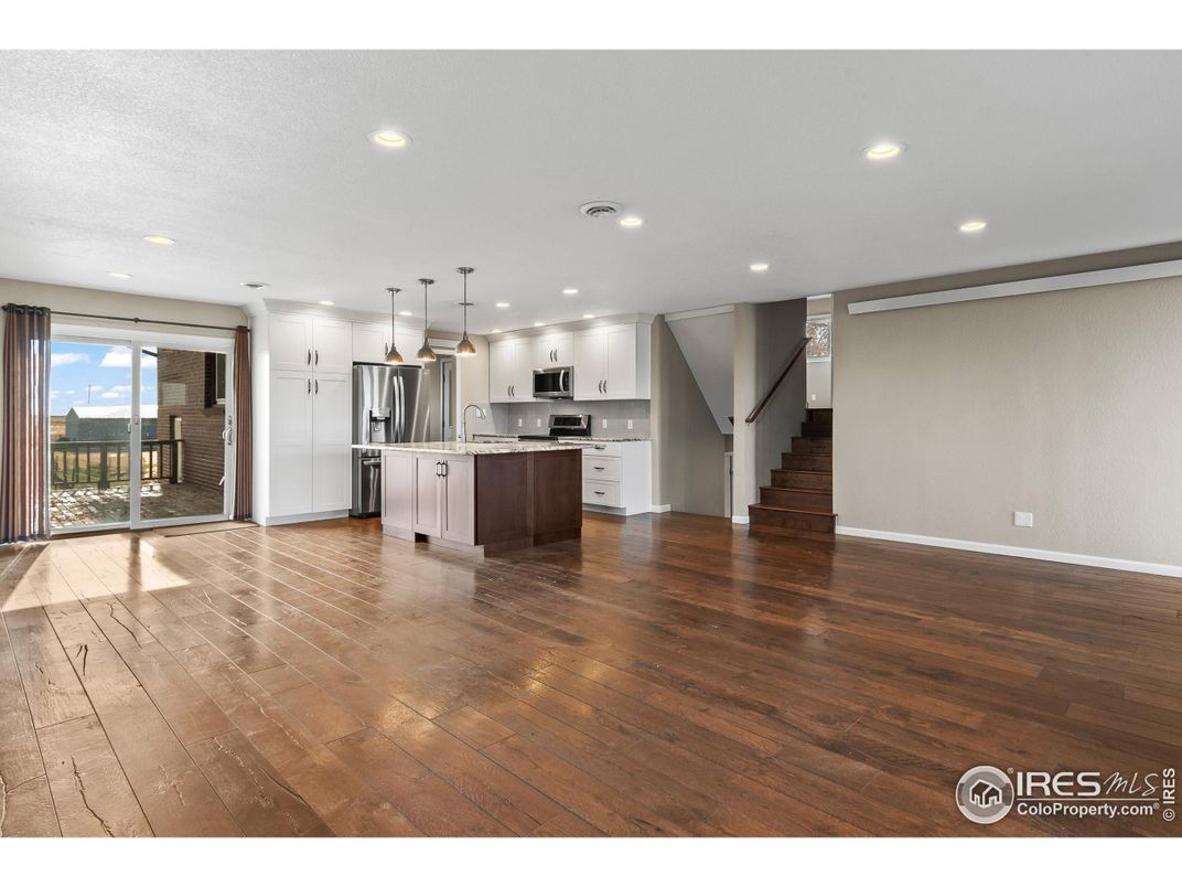 Empty room, Interior, Kitchen, Pendant Lights, Recessed Lighting, Stainless Steel Appliances, Wood Texture Flooring