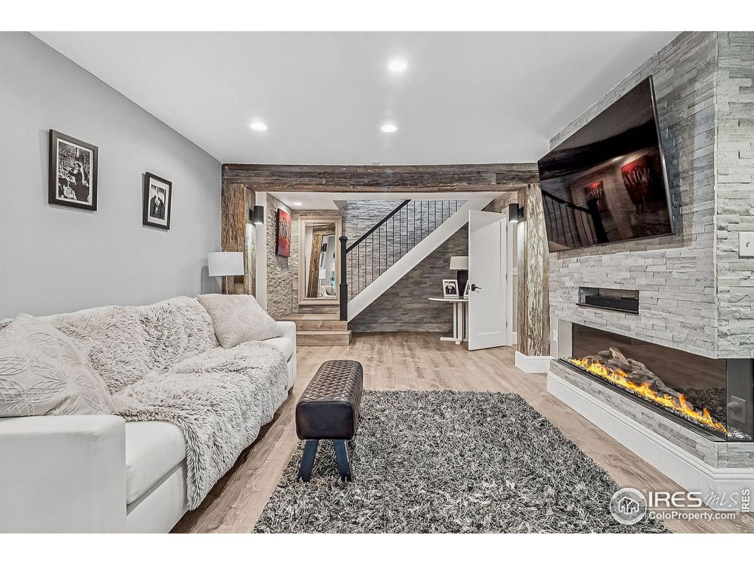 Fireplace, Interior, Living room, Recessed Lighting, Stone Walls, Wood Texture Flooring