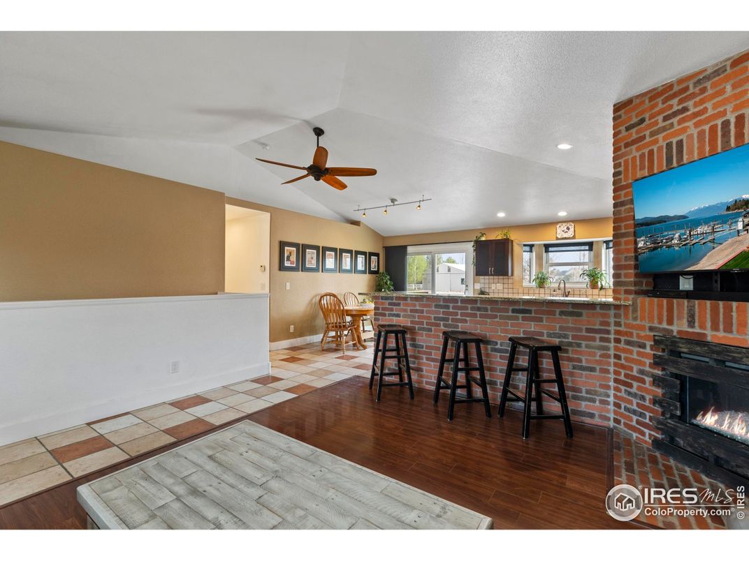 Dining room, Fireplace, Interior, Recessed Lighting, Stone Walls, Wood Texture Flooring