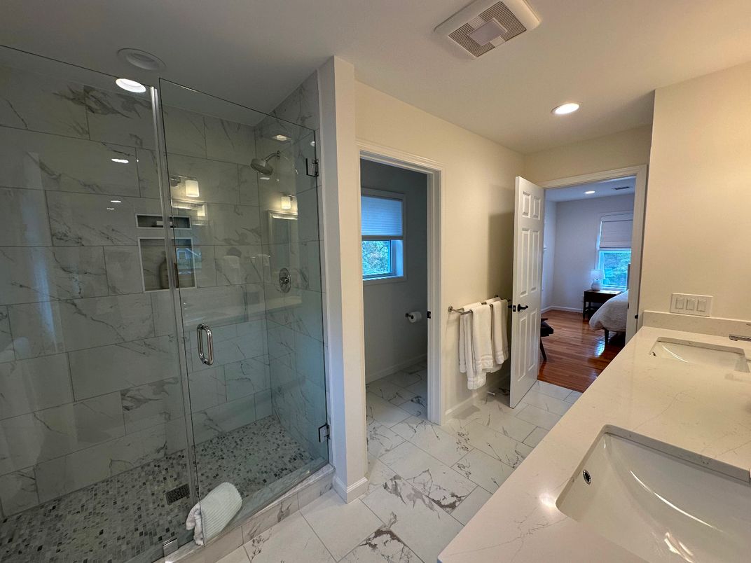 Bathroom, Dual Sink Vanities, Glass Shower, Interior, Marble, Marble Walls, Recessed Lighting, Wood Texture Flooring