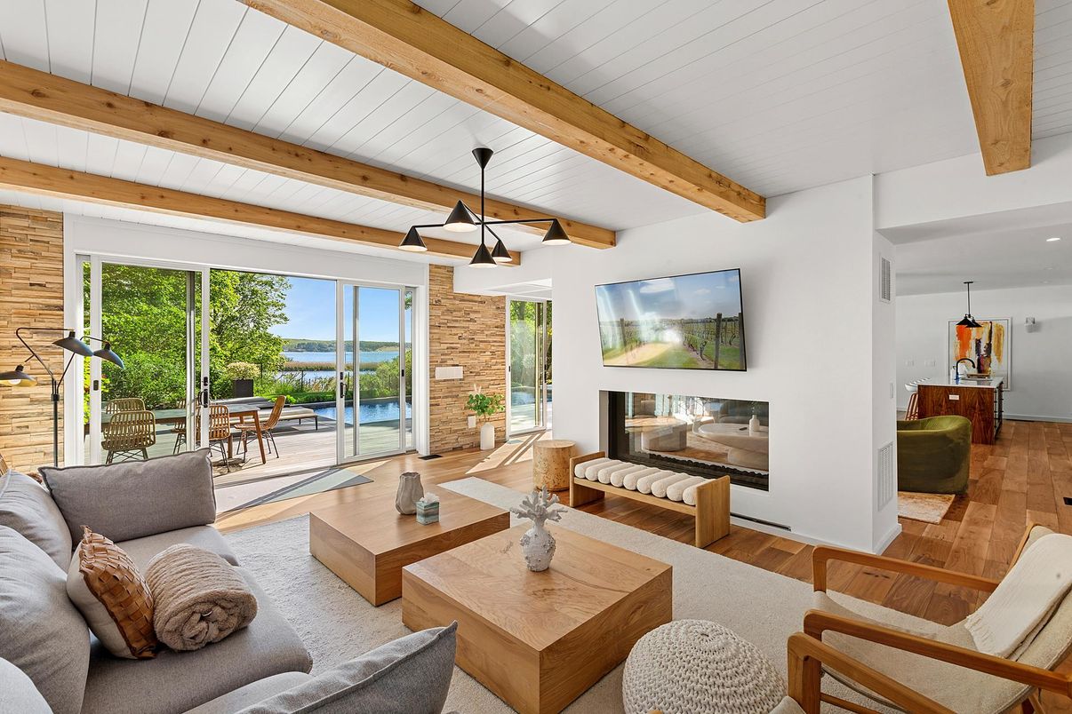 Dining room, Fireplace, Interior, Living room, Pendant Lights, Recessed Lighting, Stone Walls, Water, Wooden Beams, Wood Texture Flooring