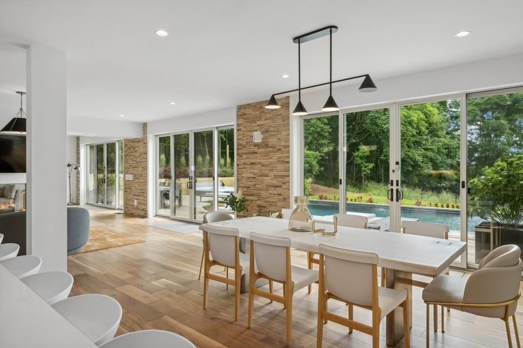 Dining room, Fireplace, Interior, Pendant Lights, Recessed Lighting, Stone Walls, Water, Wood Texture Flooring