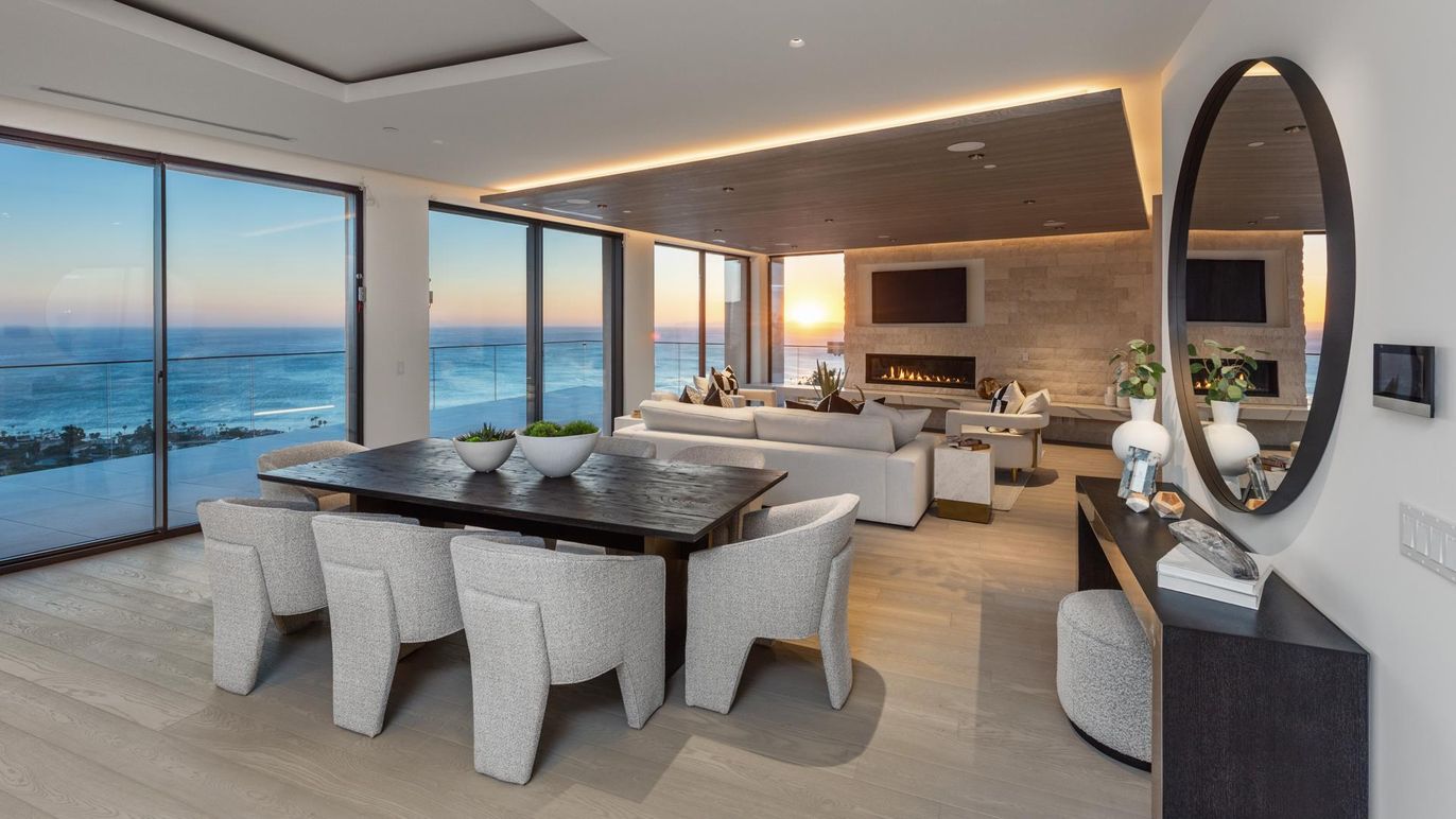 Dining room, Fireplace, Interior, Living room, Recessed Lighting, Stone Walls, Water, Wood Texture Flooring