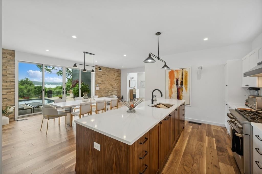 Dining room, Interior, Kitchen, Pendant Lights, Recessed Lighting, Stainless Steel Appliances, Stone Walls, Water, Wood Texture Flooring