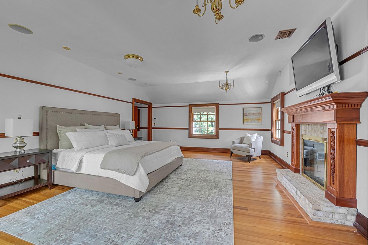 Bedroom, Chandelier, Fireplace, Interior, Recessed Lighting, Wood Texture Flooring