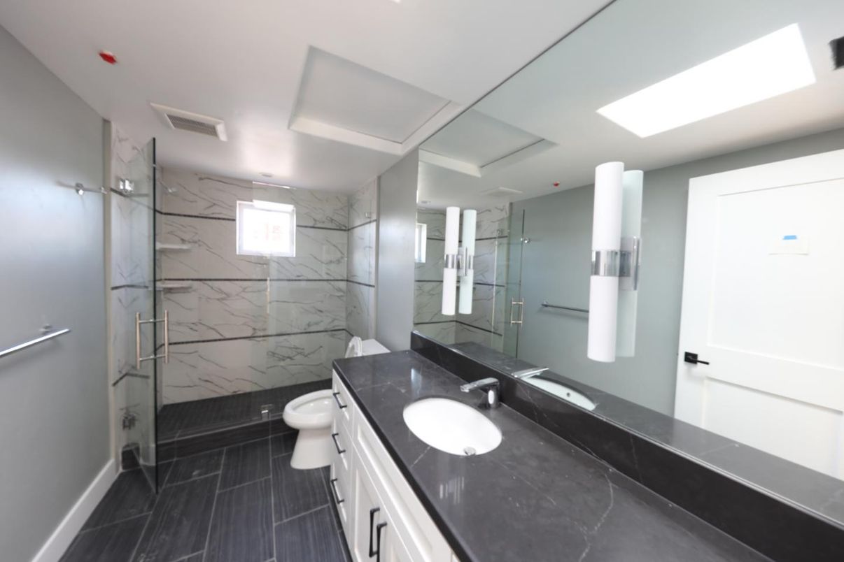 Bathroom, Dual Sink Vanities, Glass Shower, Interior, Marble, Marble Walls, Recessed Lighting