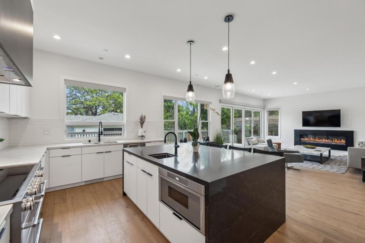 Fireplace, Interior, Kitchen, Living room, Pendant Lights, Recessed Lighting, Stainless Steel Appliances, Wood Texture Flooring