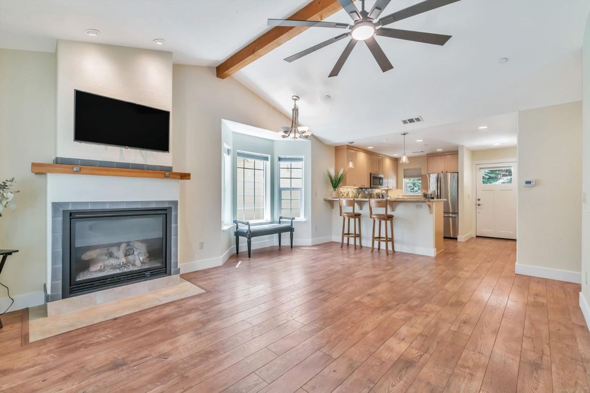 Empty room, Fireplace, Interior, Kitchen, Pendant Lights, Recessed Lighting, Stainless Steel Appliances, Wooden Beams, Wood Texture Flooring