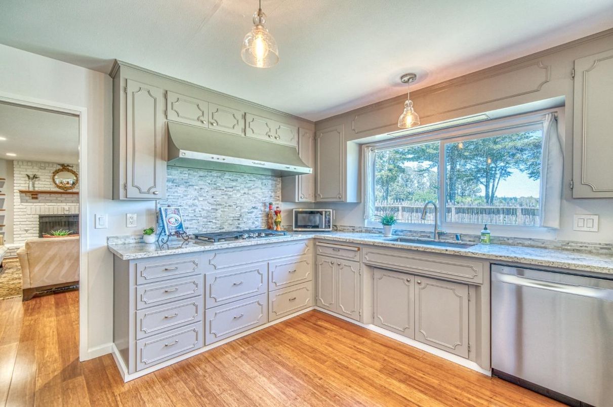 Fireplace, Interior, Kitchen, Pendant Lights, Recessed Lighting, Stainless Steel Appliances, Stone Walls, Wood Texture Flooring