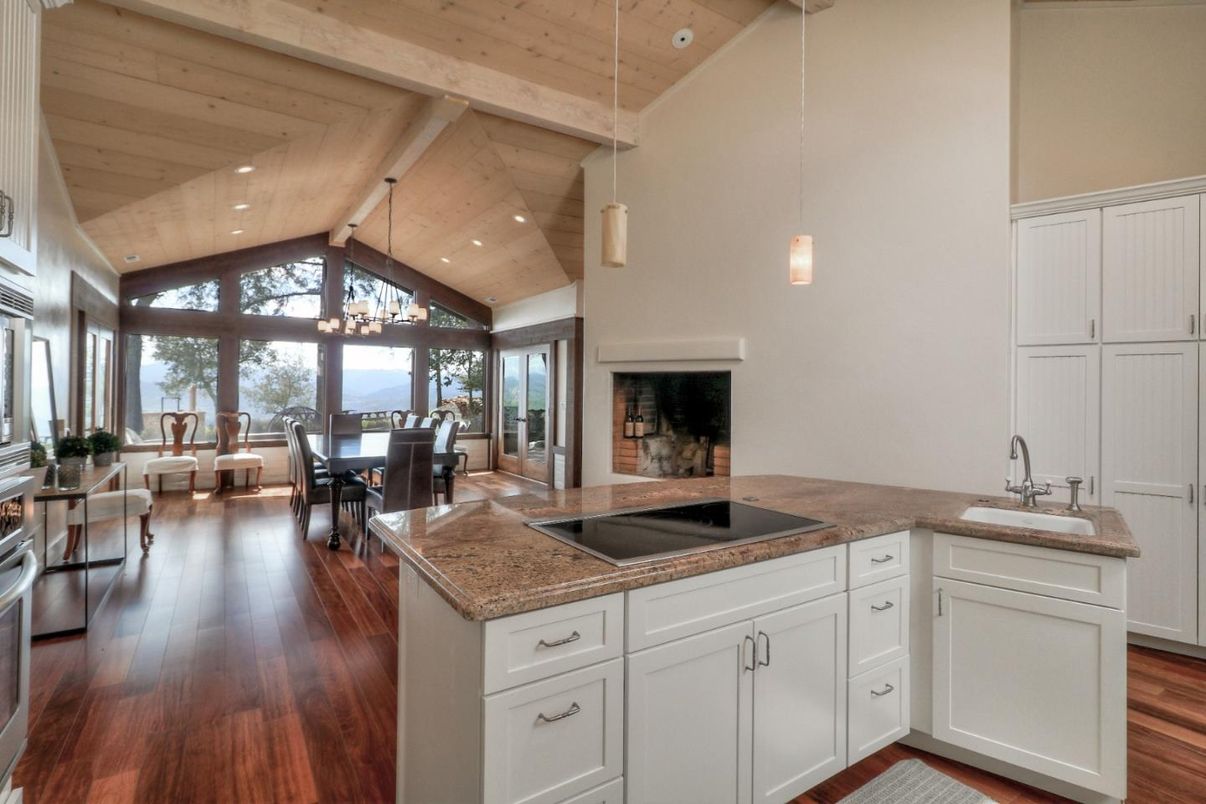 Chandelier, Dining room, Fireplace, Interior, Living room, Pendant Lights, Recessed Lighting, Wooden Ceilings, Wood Texture Flooring