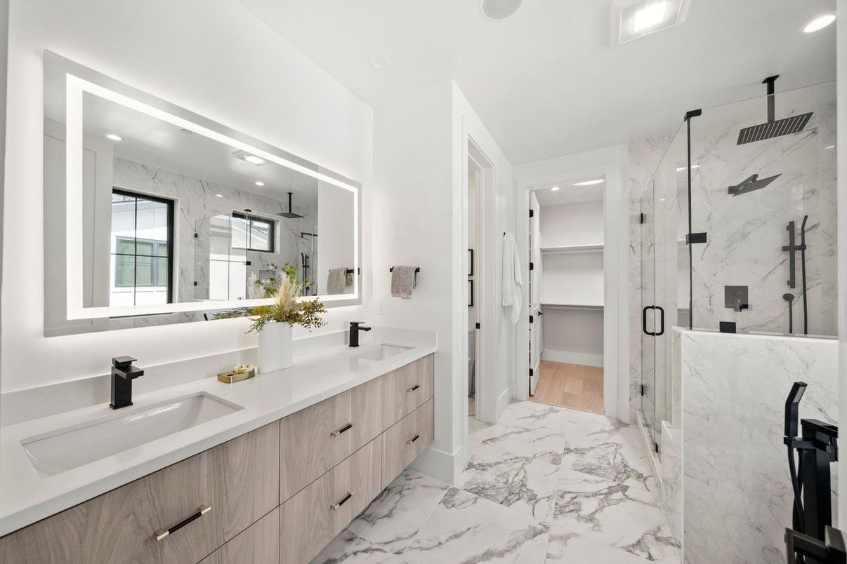 Bathroom, Dual Sink Vanities, Glass Shower, Interior, Marble, Marble Walls, Recessed Lighting, Walk-in Closets