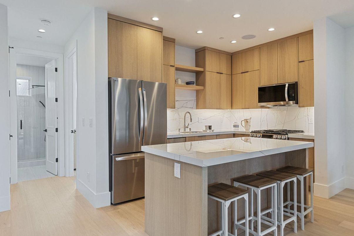 Interior, Kitchen, Marble Walls, Recessed Lighting, Stainless Steel Appliances, Wood Texture Flooring