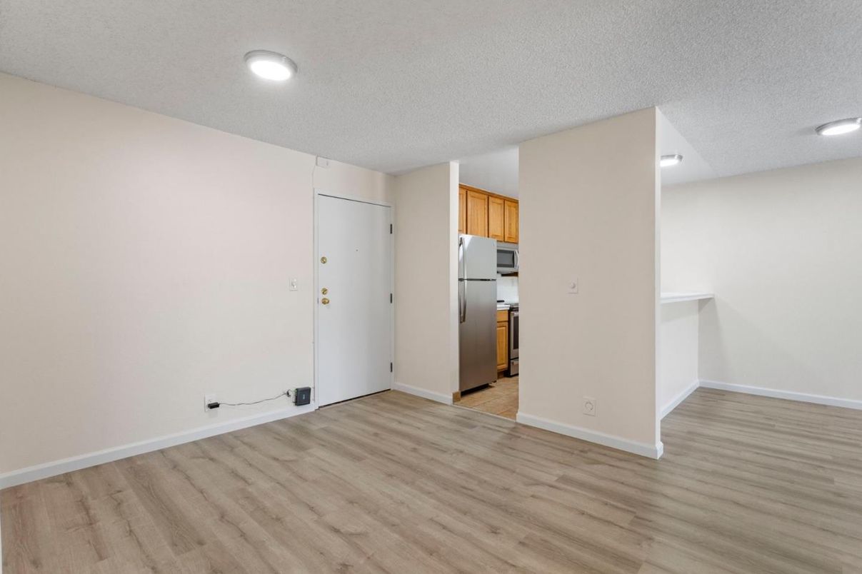 Empty room, Interior, Kitchen, Recessed Lighting, Stainless Steel Appliances, Wood Texture Flooring