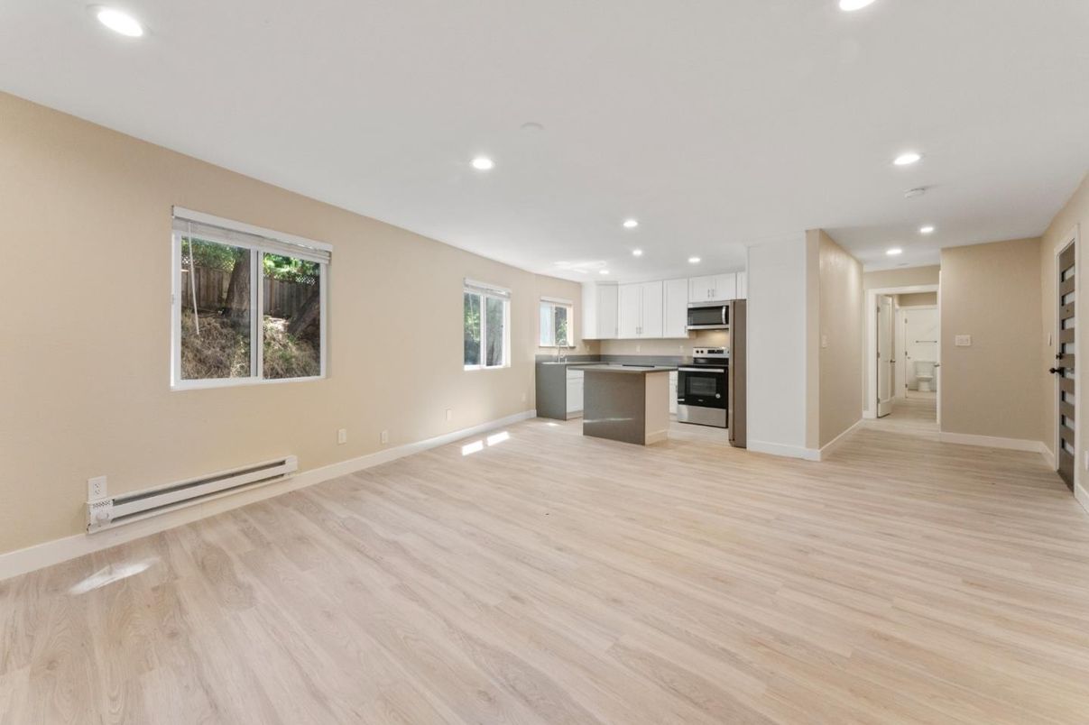 Empty room, Interior, Kitchen, Recessed Lighting, Stainless Steel Appliances, Wood Texture Flooring