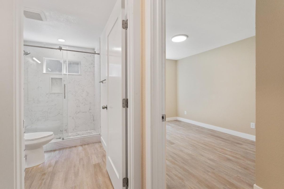 Bathroom, Glass Shower, Interior, Marble Walls, Recessed Lighting, Wood Texture Flooring