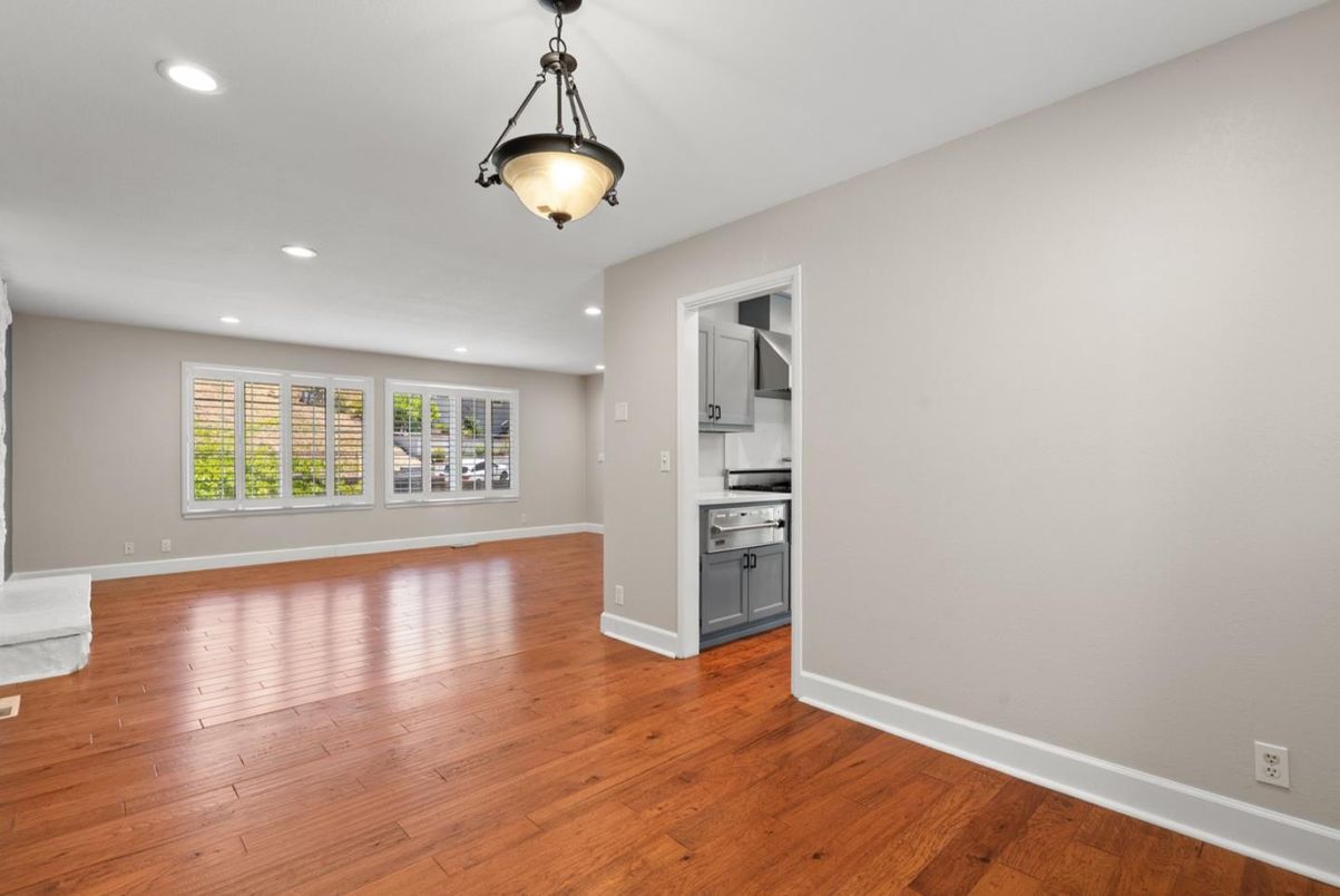 Empty room, Interior, Kitchen, Pendant Lights, Recessed Lighting, Stainless Steel Appliances, Wood Texture Flooring