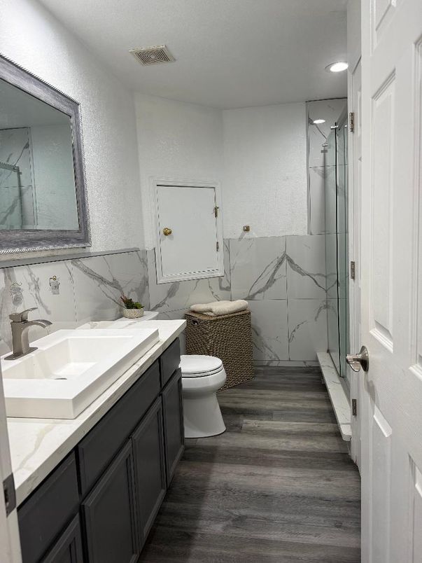 Bathroom, Glass Shower, Interior, Marble Walls, Recessed Lighting, Wood Texture Flooring