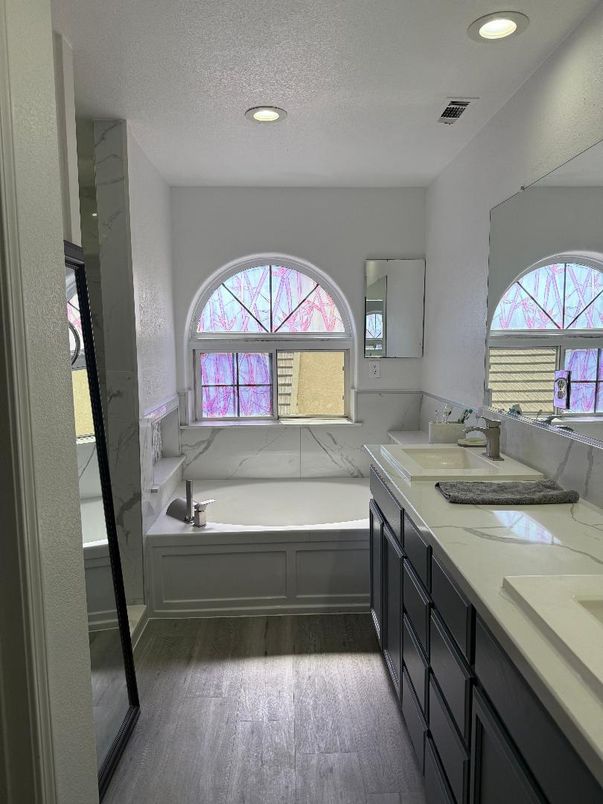 Bathroom, Dual Sink Vanities, Interior, Marble Walls, Recessed Lighting, Wood Texture Flooring