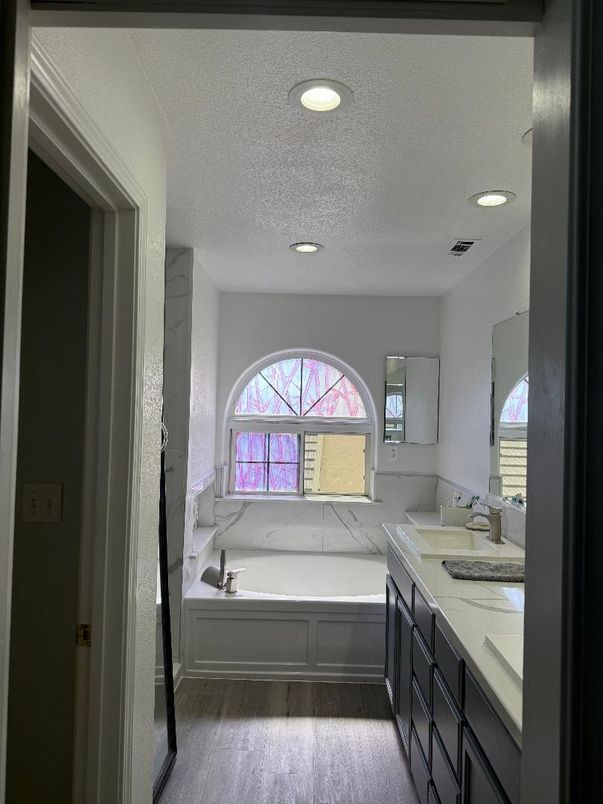 Bathroom, Dual Sink Vanities, Interior, Marble Walls, Recessed Lighting, Wood Texture Flooring