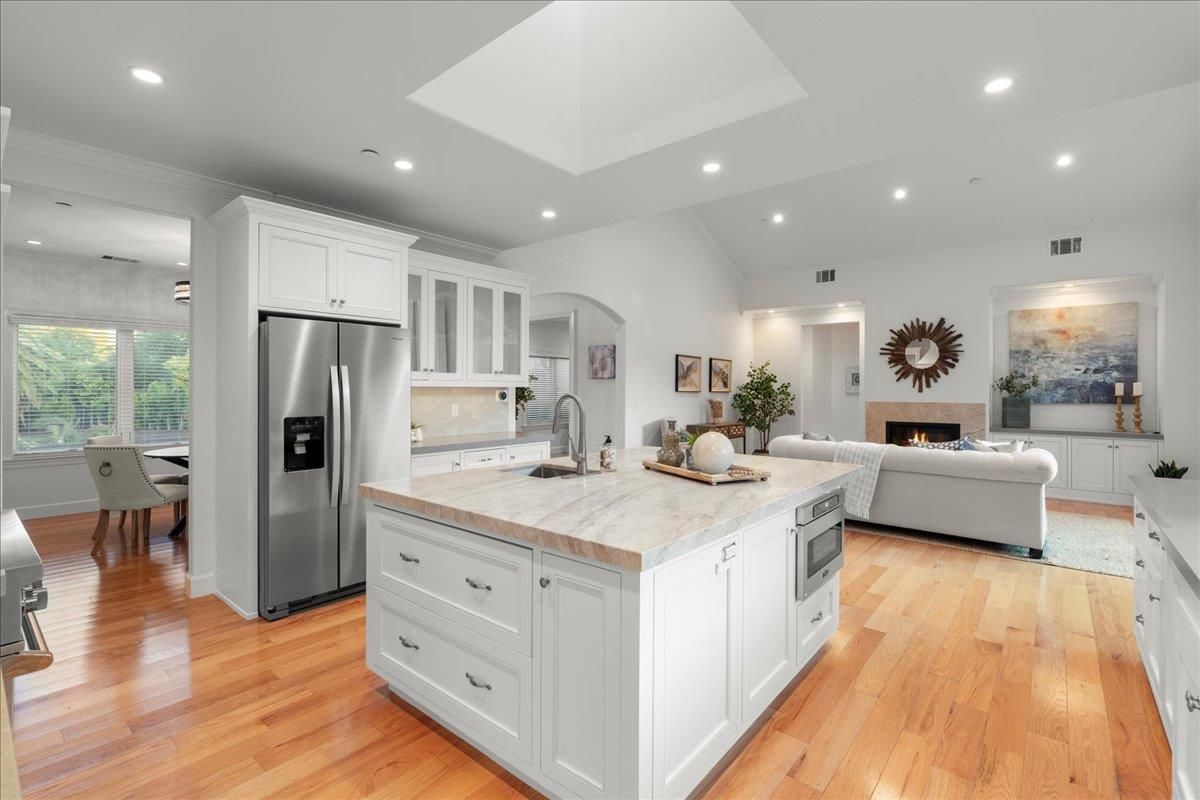 Fireplace, Interior, Kitchen, Living room, Recessed Lighting, Stainless Steel Appliances, Wood Texture Flooring
