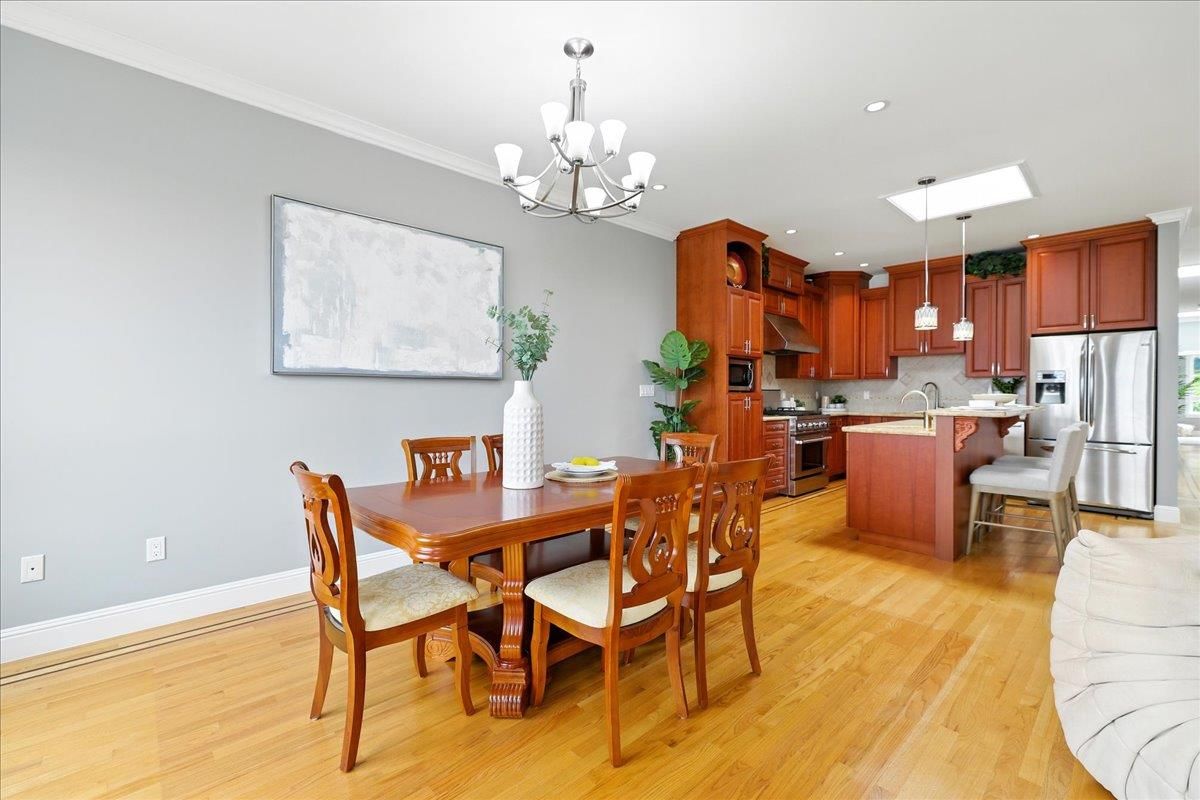 Chandelier, Dining room, Interior, Kitchen, Pendant Lights, Recessed Lighting, Stainless Steel Appliances, Wood Texture Flooring