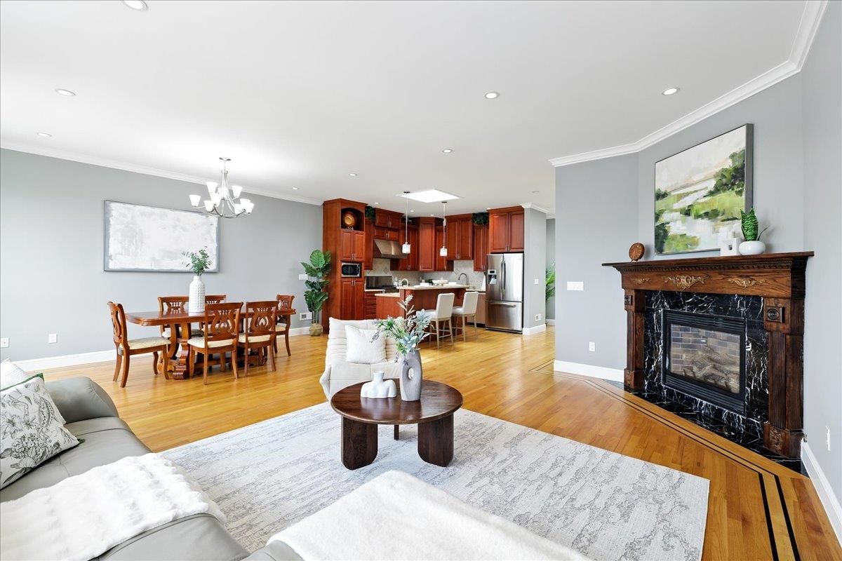 Chandelier, Dining room, Fireplace, Interior, Kitchen, Living room, Recessed Lighting, Stainless Steel Appliances, Wood Texture Flooring