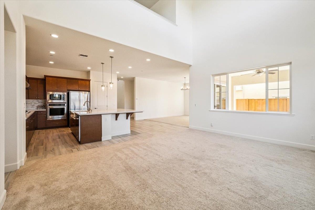 Empty room, Interior, Kitchen, Pendant Lights, Recessed Lighting, Stainless Steel Appliances, Wood Texture Flooring